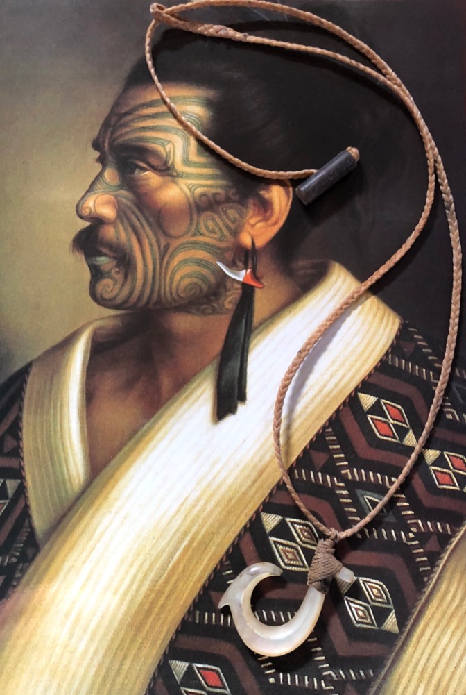 A portrait of an ancient Māori king and a hand-carved shell fish hook