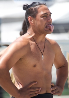 A Māori dancer performs a welcoming Kapa Haka for arriving ocean sailors. An extended tongue is said to be an expression of the wairua, or spirit, temporarily emerging from the body during the dance
