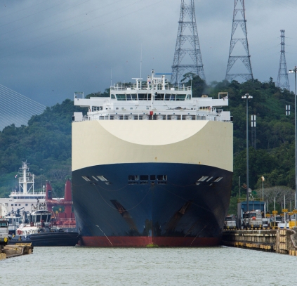 A massive container ship squeezes (by inches) into the Mirafllores Locks of the Panama Canal