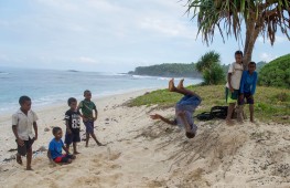 Local schoolboy and future Vanuatu Olympian Paul Duboisé, 11, shows off a standing body flip